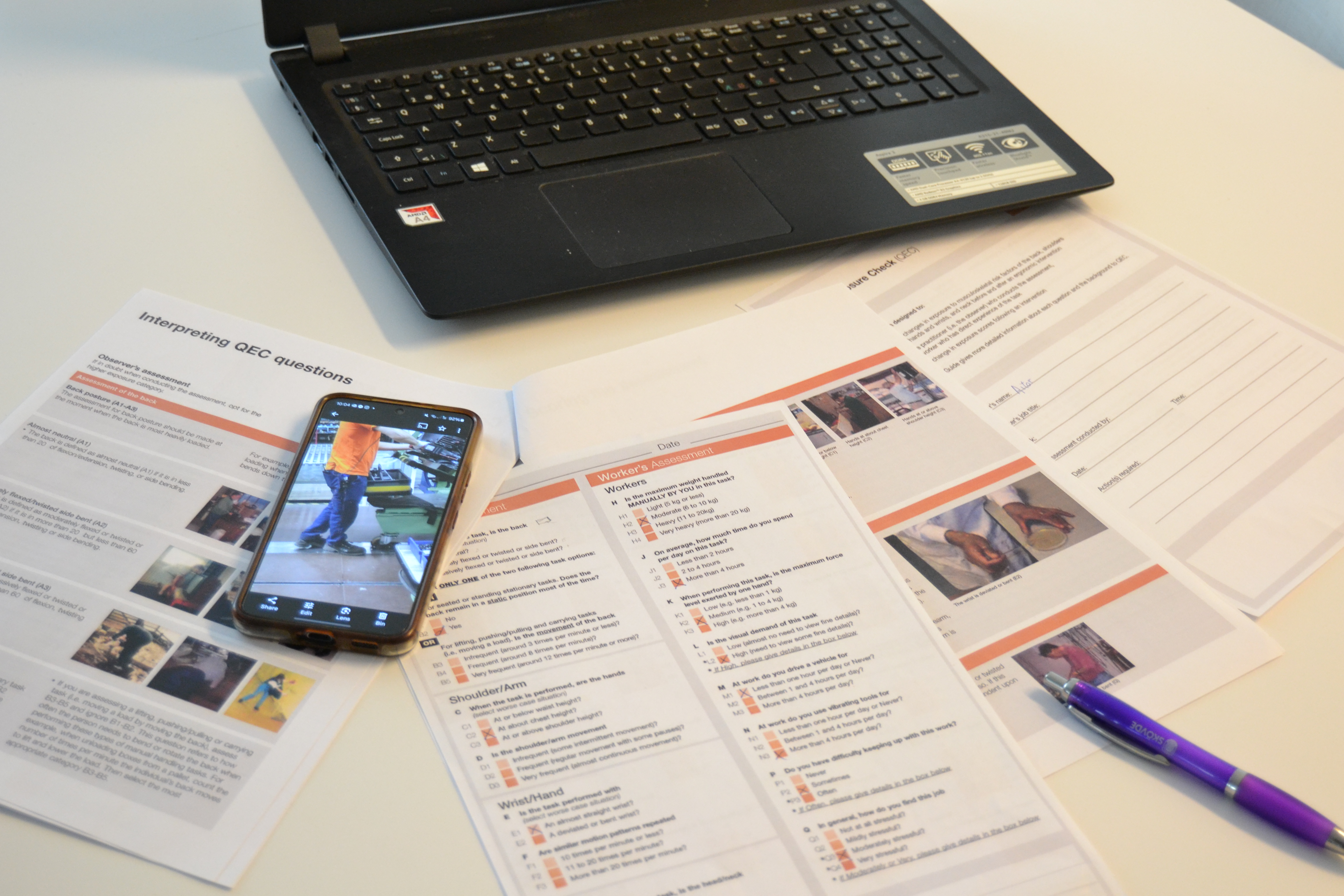 Ergonomist using phone and paper forms in the field